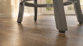 Installed MagniGlide system beneath a chair leg with the high-density virgin wool felt contacting the floor